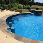Round Pool with pool side underwater stone bar stools, infinity edge pool