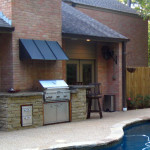 Outdoor Kitchen with stainless steel grille and small overhang