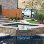 square spa with overflow into pool