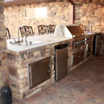 stainless steel outdoor kitchen with wrought iron bar stools