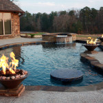 2 fire features with central blue tiled table top in pool
