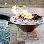 pool side stone fire feature with water spout