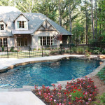 custom design razorback shaped pool with house in background