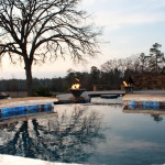 blue tiled pool with fire accents