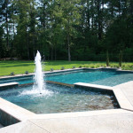 pentagon shaped spa with rectangular pool with central water fountain