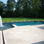 custom pool with water channel feeding spa and pool with fountain