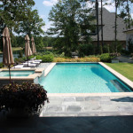 light blue pool with chaise lounge chairs and upper deck spa