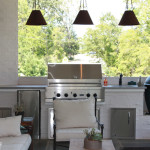 white outdoor kitchen with pendant lights