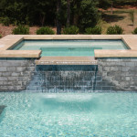 rectangular spa with overflow channel into pool