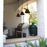 3 pendant light over white outdoor kitchen