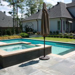 square hot tub with over flow channel into pool