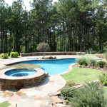 stone round hot tub custom built with pool