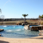 rounded pool with multiple fountains and infinity edge