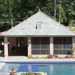 4 brick column pool house with pitched roof and patio
