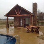 rustic wood pool house with fireplace