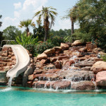 natural river rock waterfall with pool slide