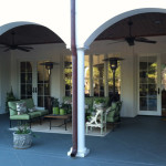 Arched with white column outdoor living space and green outdoor furniture