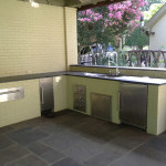 light colored painted brick outdoor kitchen with stainless steel appliances