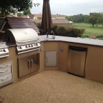 L-shaped outdoor kitchen with stainless steel appliances